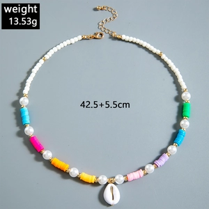 Detail of bohemian starfish beaded necklace with shell pendant and colorful clay discs