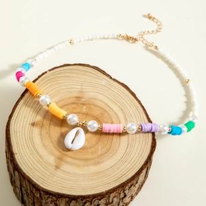 Close-up of bohemian shell necklace with colorful heishi beads and starfish charm