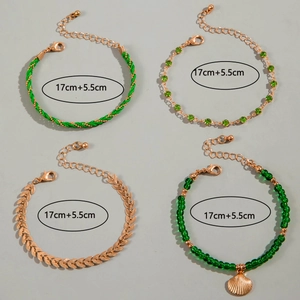 Detail of four-piece green beaded shell bracelet set showing 17cm plus 5.5cm length