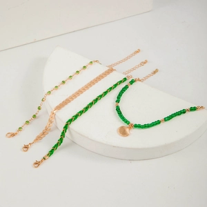 Bohemian multilayer green bead and shell charm bracelet set on minimalist display