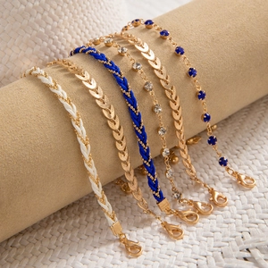 Detail of bohemian six-piece multi-layer bracelets with beads and shell accents