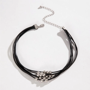 Detail of multi-layer black cord choker with thirteen silver metal beads and lobster clasp