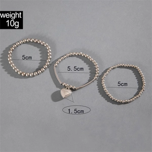 Detailed view of triple silver bead bracelets with heart pendant and size dimensions