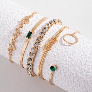 Five-piece gold jewelry set with heart charm, green gemstone bracelet and infinity bangle
