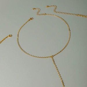 Detail of gold-plated body chain lobster clasp and adjustable link chain extender