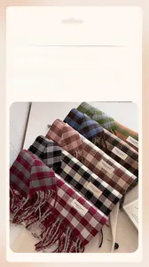 Detail of soft plaid cashmere-like scarf with fringe and Elegant Classic label
