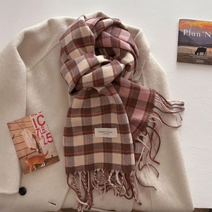 Close-up of thick plaid scarf texture with Elegant & Classic label and fringe details