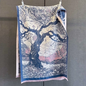 Detailed view of winter jacquard scarf featuring artistic tree patterns and pink tassels