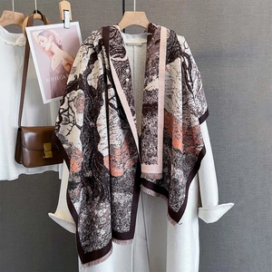 Detailed texture of jacquard floral scarf with artistic pattern and tassel edges