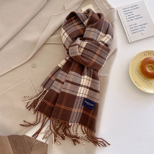 Detail of classic plaid scarf tassel with Elegant & Classic woven label on thick fabric