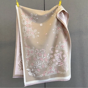 Close-up of elegant floral jacquard pattern and tassel edges on thick pashmina scarf