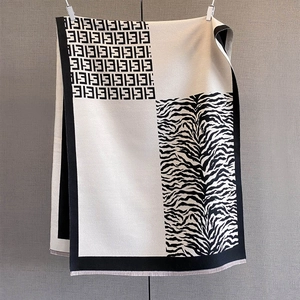 Macro detail of leopard zebra jacquard scarf with premium stitching and fine tassels