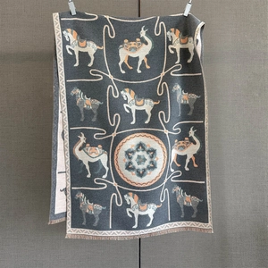 Macro detail of ethnic horse and camel pattern on grey floral pashmina with tassels