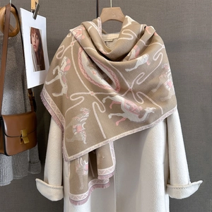 Detail of winter scarf with jacquard carousel pattern and fringe edge on a coat