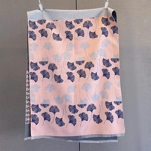 Detail of pink cashmere-like scarf with ginkgo leaf patterns and delicate fringe edges