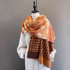 Detail of cashmere-like scarf showing ginkgo leaf patterns and houndstooth texture