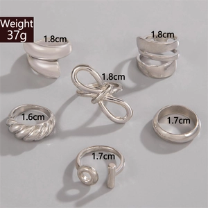 Detail view of 6pcs silver geometric rings set with twisted and smooth textured bands