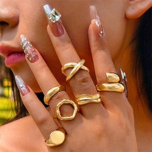 Golden geometric ring set featuring layered wave and hollow hexagonal vintage designs
