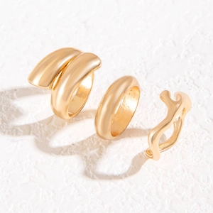 Three-piece gold minimalist ring set with wavy and intertwined polished metal designs