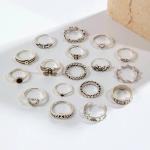 Flat lay of 17 vintage silver rings featuring butterfly, moon and heart shaped motifs