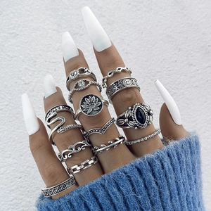 Close-up of bohemian vintage silver rings set with snake, moon and floral patterns