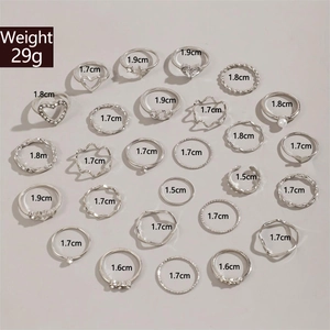 Detailed set of 24 silver rings featuring butterfly, moon and pearl designs in varied sizes