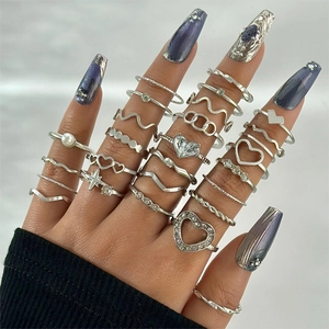 Close-up of vintage silver ring set with butterfly, moon, and pearls on model hand