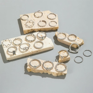 Detailed set of 19 vintage silver rings featuring butterfly and moon motifs on stone slabs