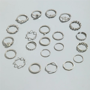 Detailed overhead view of a 21-piece silver ring set featuring butterfly and moon motifs