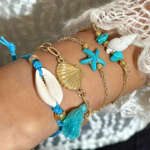 Bohemian beach bracelet set with starfish shells and pearls worn on a wrist