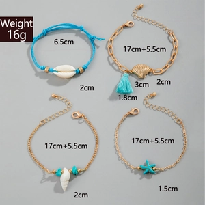 Detail of four-piece ocean charm bracelet set with shells, starfish and turquoise beads
