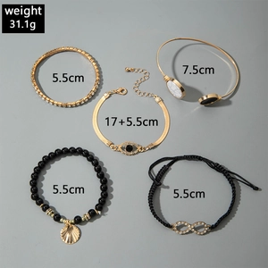 Detailed view of 5-piece beach bracelet set with starfish shells and evil eye charms
