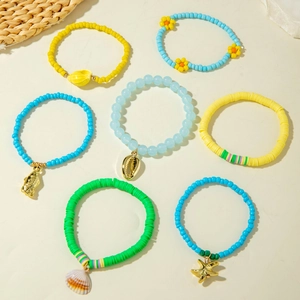 Close-up of bohemian summer bracelets with sea shells, starfish, and colorful beads