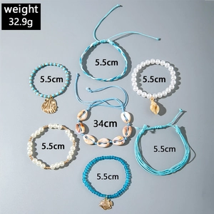 Detail view of 7-piece bohemian beach jewelry set with pearls, shells, and blue beads