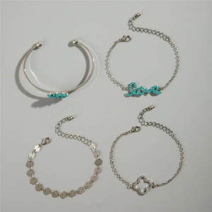 Detail of bohemian silver bracelet set with turquoise beads and clover charm