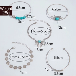 Detailed view of bohemian turquoise leaf and butterfly 5-piece silver bracelet set
