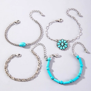Detail view of 4-piece bohemian turquoise bracelet set with flower and leaf charms