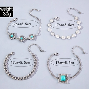 Detail of four silver bohemian bracelets featuring turquoise stones and daisy patterns