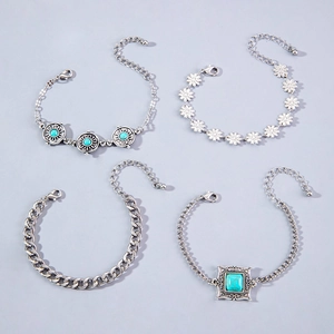 Detail of four-piece bohemian silver-plated bracelets set with turquoise floral charms