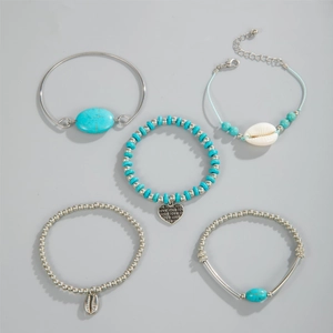 Detail of bohemian five-piece bracelet set with turquoise beads, shells and silver love charm