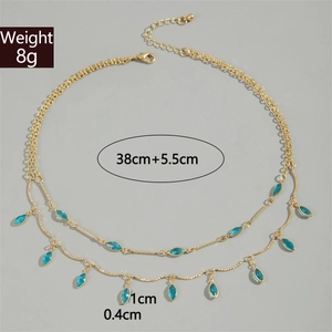 Detail of double-layer gold necklace showing 8g weight and 38cm chain length specs