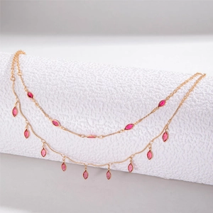 Double-layered gold chain necklace featuring pink marquise-cut crystal pendants