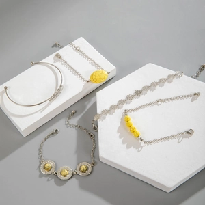 Detail of bohemian silver bracelets with yellow turquoise charms and feather motif