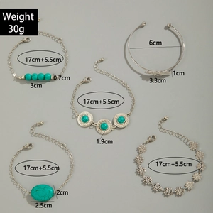 Detailed view of bohemian silver bracelets set featuring turquoise beads and leaf charms