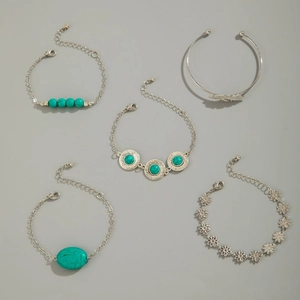 Detail of 5-piece bohemian silver bracelet set featuring turquoise stones and leaf charm