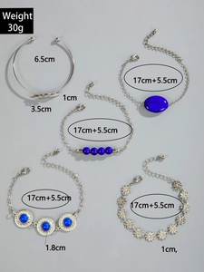 Detailed view of 5-piece silver bohemian bracelet set with turquoise and floral charms