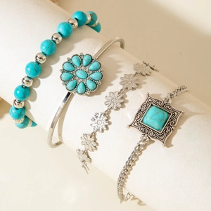 Detail of four-piece Bohemian turquoise and silver-tone leaf charm bracelet set