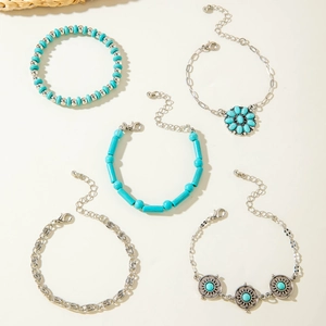 Close-up of bohemian silver bracelet set with turquoise beads and leaf charms