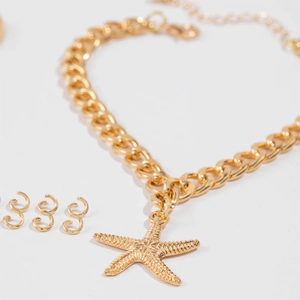 Close-up of golden starfish pendant on textured chunky chain with matching earring set