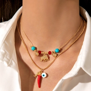 Hawaiian beach layered necklace with chili, evil eye, and golden elephant pendants